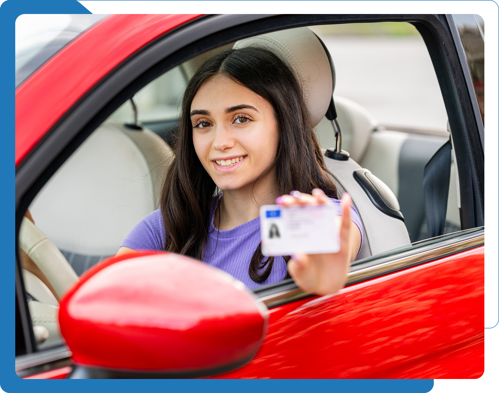 Person holding driver's license inside car. Person holding driver's license inside car.