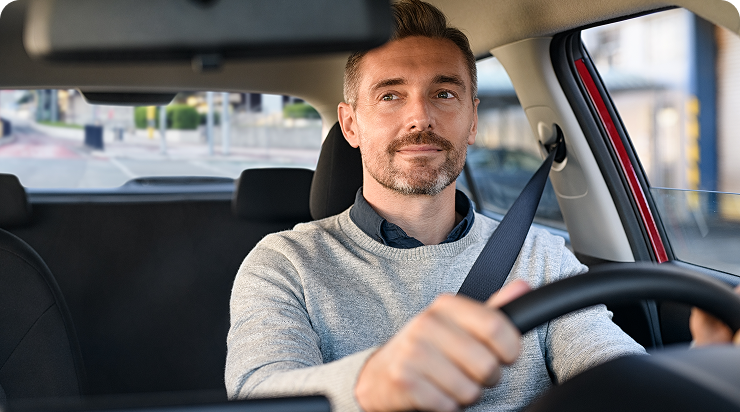 Man driving a car, smiling confidently. Man driving a car, smiling confidently.