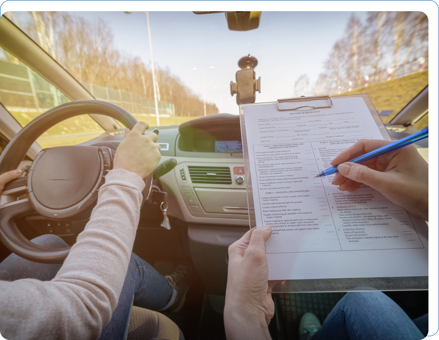 Driving test with examiner and clipboard.
