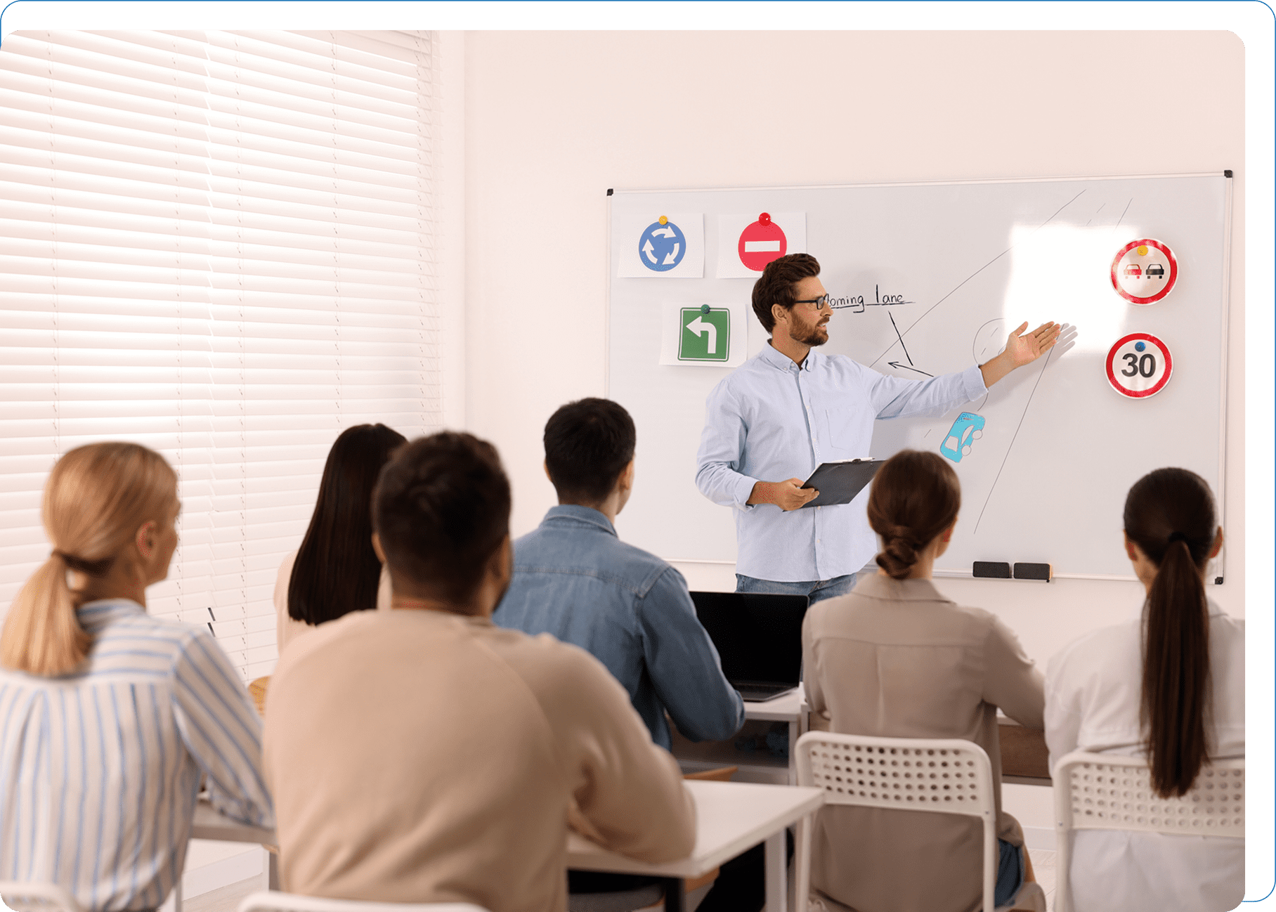 Classroom with instructor teaching road signs.