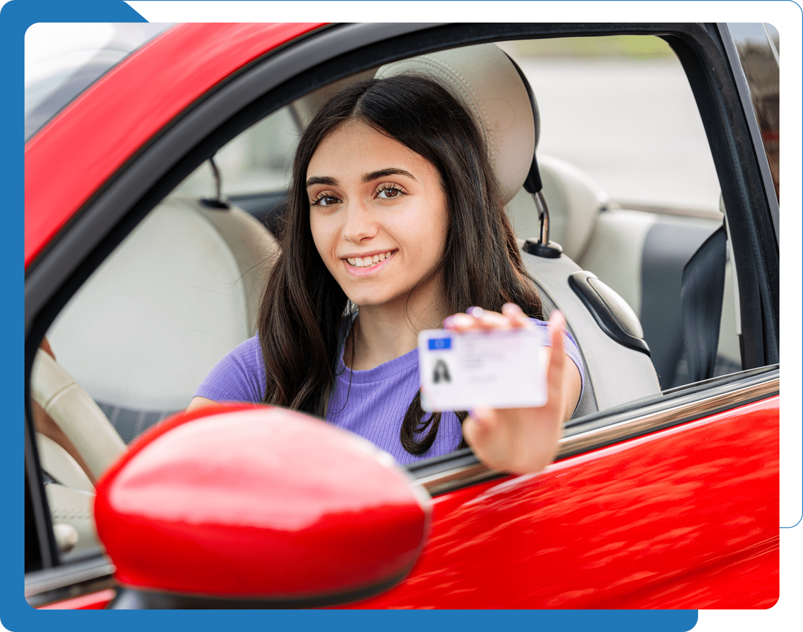 Person holding driver's license inside car.